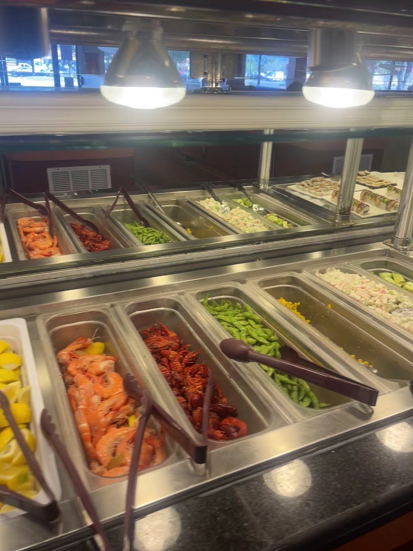 Sushi pieces arranged on a buffet counter.